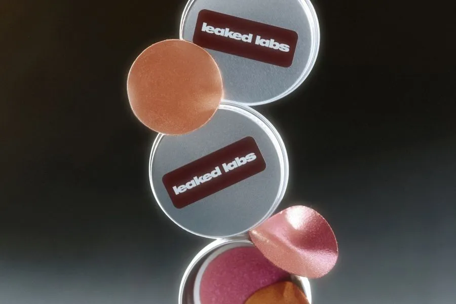 Makeup tins that say Leaked Labs.